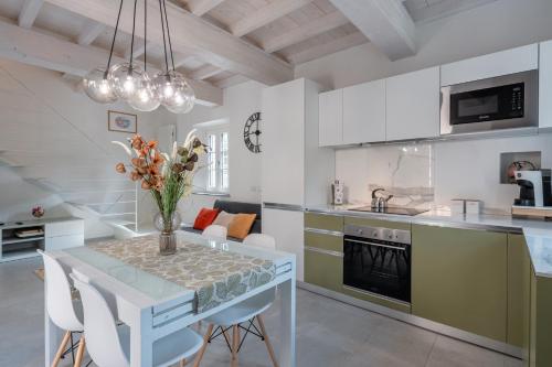 a kitchen with a table and chairs in a room at Charming Tuscan Stone House in Pescaglia
