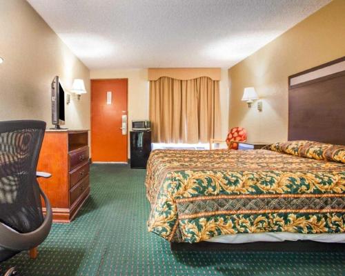 a hotel room with a bed and a television at Rodeway Inn Mount Laurel Hwy 73 in Mount Laurel