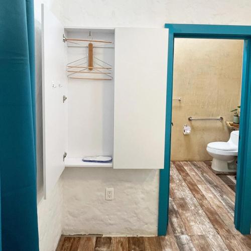 a bathroom with a toilet and a door open at Bellaphia Hotel Boutique in Filandia