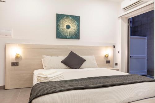 a bedroom with a large bed with a blue door at Guesthouse No. 48 in Msida