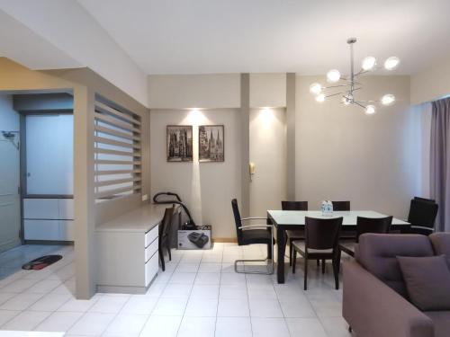 a living room and dining room with a table and chairs at Seri Bukit Ceylon By SS in Kuala Lumpur