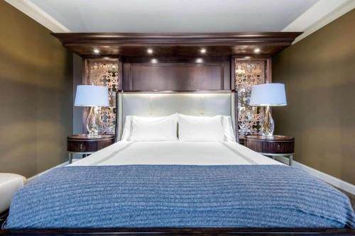 a bedroom with a large bed with two lamps at Curtiss Hotel, an Ascend Collection Hotel in Buffalo