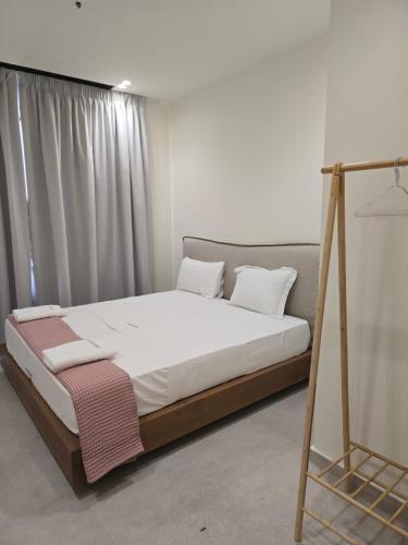 a bed with a wooden frame in a room at Drymadhes Villas & appartments in Himare