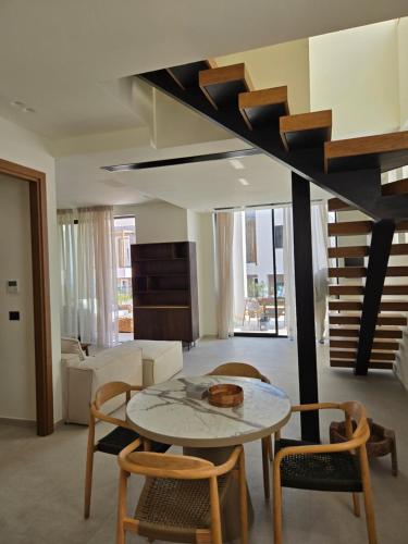 a living room with a table and chairs at Drymadhes Villas & appartments in Himare