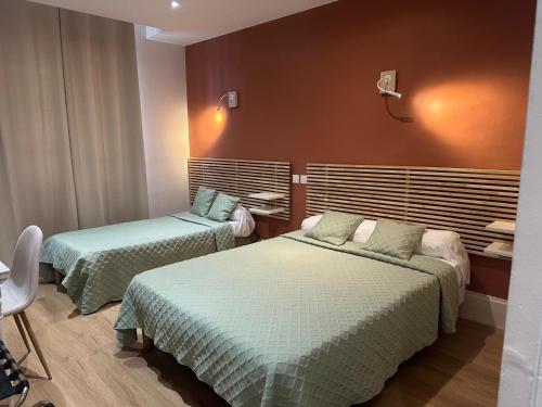 a hotel room with two beds in a room at Hotel Azur in Lyon