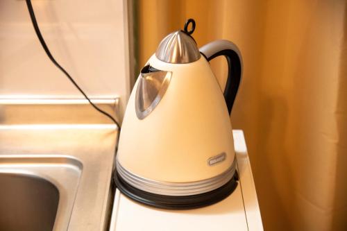 a tea kettle sitting on a counter next to a sink at Scent of Asia in Yokohama
