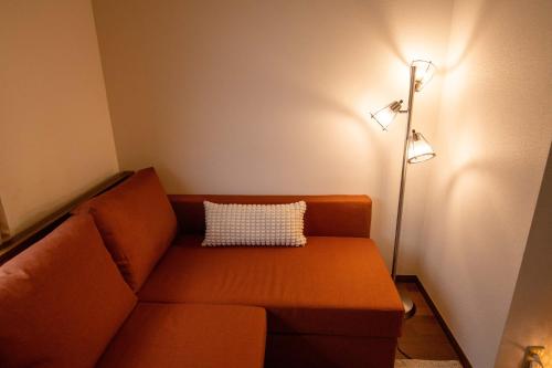 a living room with a couch and a lamp at Scent of Asia in Yokohama