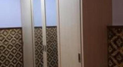 a white cabinet with a window in a room at Fafa Hill Hotel and Resort in Bogor