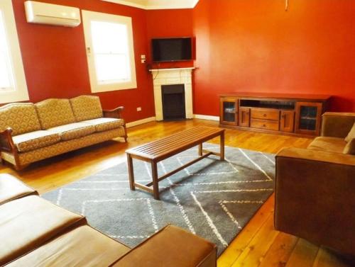 a living room with a couch and a table at Eddy's of Canowindra in Canowindra