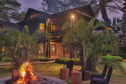 a house with a fire in front of it at Kibo Villa Amboseli in Amboseli