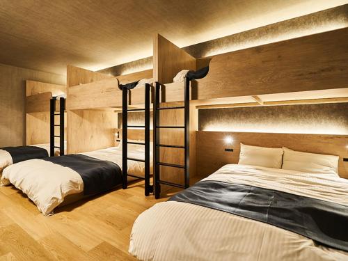 two beds in a room with two bunk beds at Rakuten STAY VILLA Awaji 101 3 bank beds, Capacity of 9 persons in Minamiawaji
