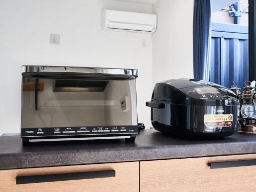 a toaster oven sitting on top of a kitchen counter at Rakuten STAY VILLA Awaji 103 3 bank beds, Capacity of 9 persons in Minamiawaji