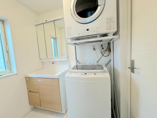 a kitchen with a washing machine and a sink at Grande Ortho Okinawa Villa Onna 3 - Vacation STAY 83615 in Onna