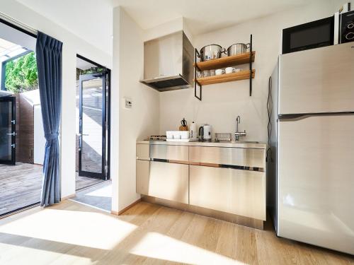 a kitchen with a sink and a refrigerator at Rakuten STAY VILLA Awaji 104 4 double beds, capacity of 8 persons in Minamiawaji