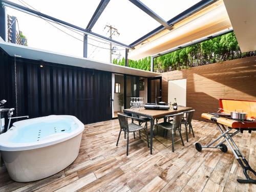 a large bathroom with a tub and a table and chairs at Rakuten STAY VILLA Awaji 104 4 double beds, capacity of 8 persons in Minamiawaji
