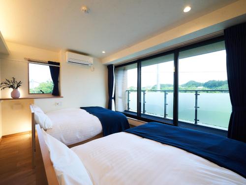 Katil atau katil-katil dalam bilik di Rakuten STAY HOUSE Kujukuri Ichinomiya 106 3LDK with BBQ terrace pet allowed