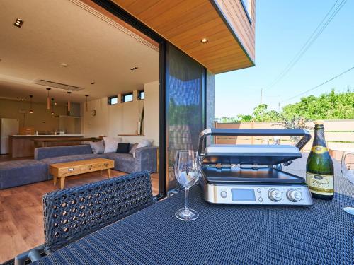 a table with a grill and a wine glass on it at Rakuten STAY HOUSE Kujukuri Ichinomiya 106 3LDK with BBQ terrace pet allowed in Ichinomiya