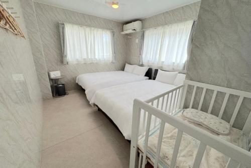 a small bedroom with a bed and a crib at Grande Ortho Okinawa Villa Onna 3 - Vacation STAY 91321 in Onna