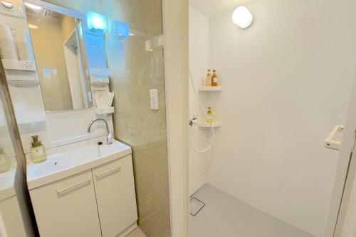 a white bathroom with a sink and a shower at Grande Ortho Okinawa Villa Onna 3 - Vacation STAY 91321 in Onna