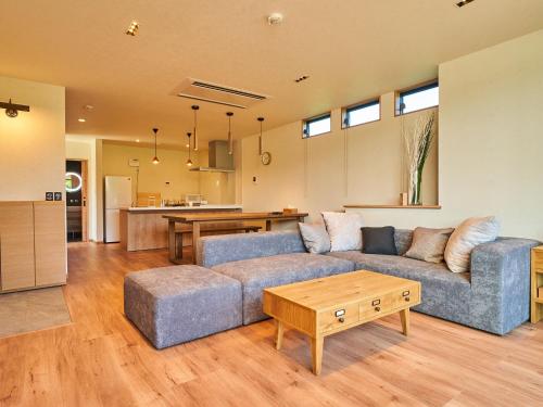 a living room with a couch and a table at Rakuten STAY HOUSE Kujukuri Ichinomiya 102 3LDK with BBQ terrace in Ichinomiya