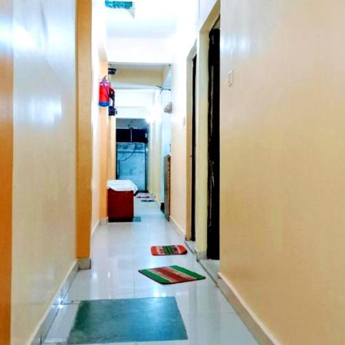a hallway of an office with mats on the floor at Hotel The Shivay Varanasi Near Kashi Vishwanath Temple in Varanasi
