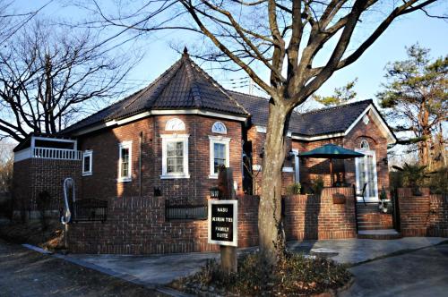 a brick house with a sign in front of it at Nasu Kogen KIRIN House Suite villa - Vacation STAY 83276 in Nasu-yumoto