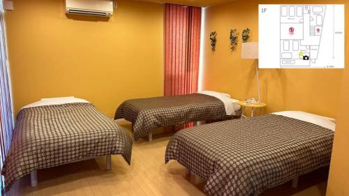 a room with two beds in a hospital room at Kumamoto - House - Vacation STAY 83489 in Kumamoto
