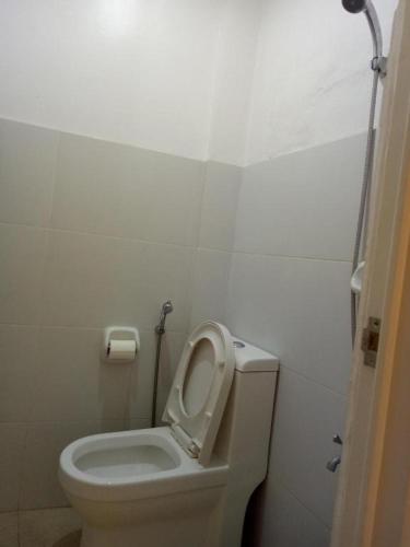 a bathroom with a toilet with the seat up at Joaquim's Lodge in Luka