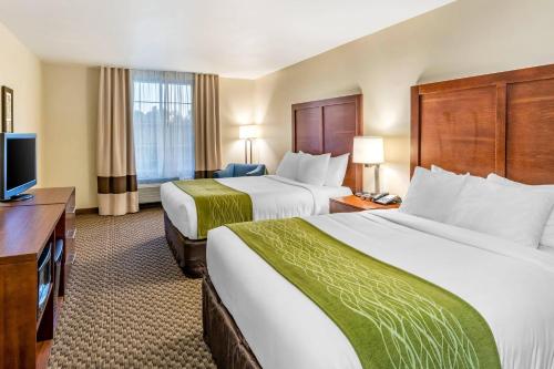 a hotel room with two beds and a television at Comfort Inn & Suites Lancaster Antelope Valley in Lancaster