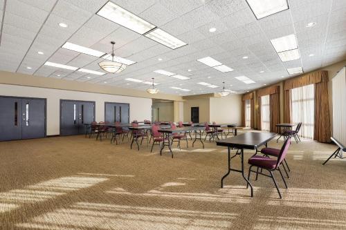 a large room with tables and chairs in it at MainStay Suites Fitchburg - Madison in Madison