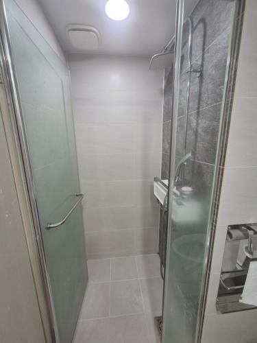 a shower with a glass door in a bathroom at 이음재서면역 in Busan