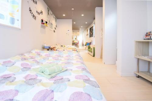 a bedroom with a large bed with a colorful bed spread at Room 301 - Vacation STAY 86506 in Fukuoka