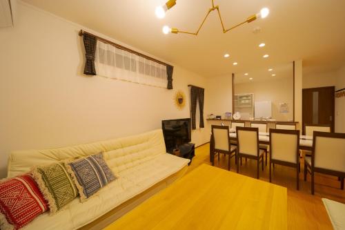 a living room with a couch and a dining room at Maple House - Vacation STAY 85725 in Fukuoka