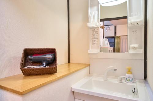 a bathroom with a sink and a mirror at SHAKUNAGE-BEKKAN - Vacation STAY 85762 in Yufuin