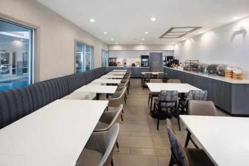 a row of tables and chairs in a restaurant at Country Inn & Suites by Radisson Asheville Downtown Tunnel Road in Asheville