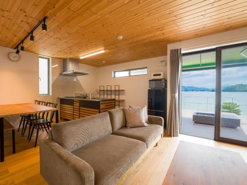 a living room and kitchen with a couch and a table at Rakuten STAY HOUSE Amakusa 102 in Kami Amakusa
