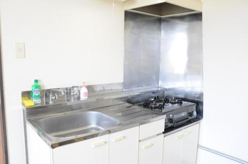 a kitchen with a sink and a stove at Ark City Asahikawa - Vacation STAY 8530 in Asahikawa