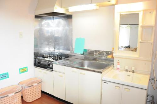 a white kitchen with a sink and a stove at Ark City Asahikawa - Vacation STAY 8523 in Asahikawa