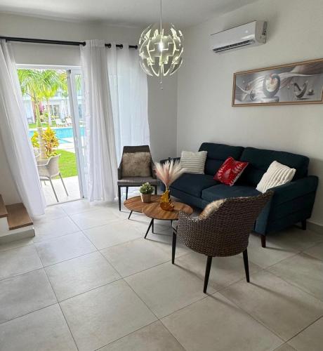 a living room with a blue couch and a table at WRparaiso in Boca Chica