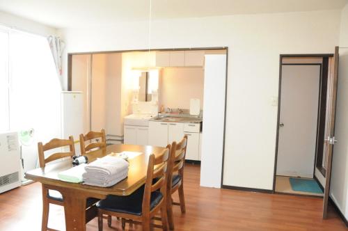 a kitchen and dining room with a table and chairs at Ark City Asahikawa - Vacation STAY 8508 in Asahikawa