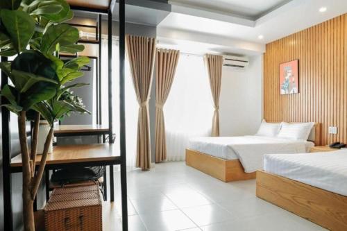 a hotel room with a bed and a desk and a bedroom at Hoang Anh Hotel Vung Tau in Vung Tau