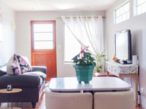 a living room with a couch and a table at Julinas Self Catering Apartments in Parow