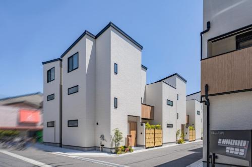 a rendering of three buildings on a street at Apartment Hotel 11 Villa Hanazonocho in Osaka