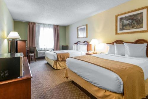 a hotel room with two beds and a television at Quality Inn Danville in Danville