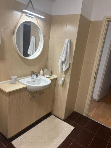 a bathroom with a sink and a mirror at Hestia Living in Scala