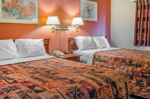 a hotel room with two beds and a phone at Rodeway Inn Allentown South in Allentown