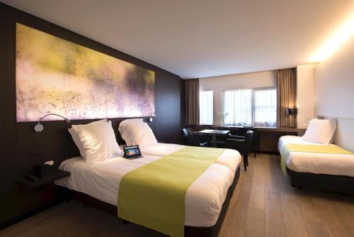 En eller flere senger på et rom på Flanders Hotel
