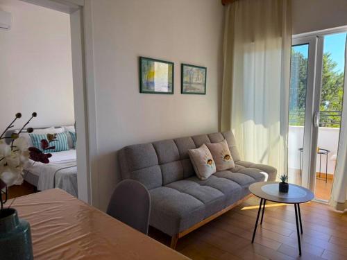 a living room with a couch and a bed at The Rooftop of Apartments Lungo Mare in Ulcinj