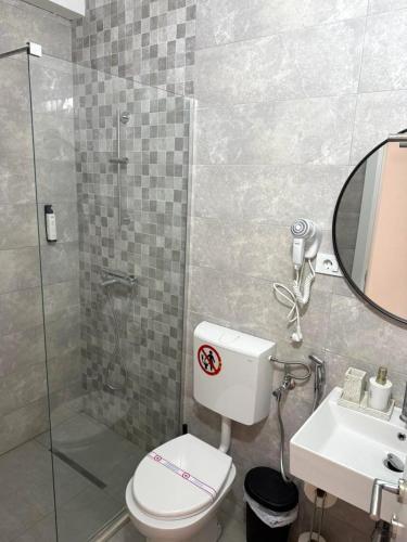 a bathroom with a toilet and a sink and a shower at The Rooftop of Apartments Lungo Mare in Ulcinj