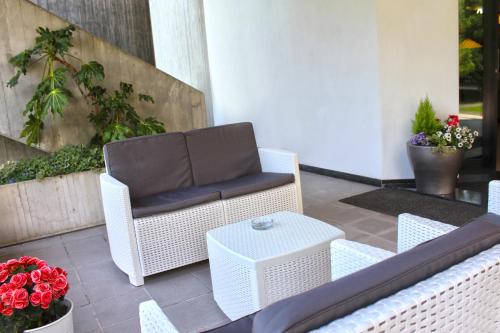a wicker chair and a table on a patio at Park Hotel in Castrocaro Terme
